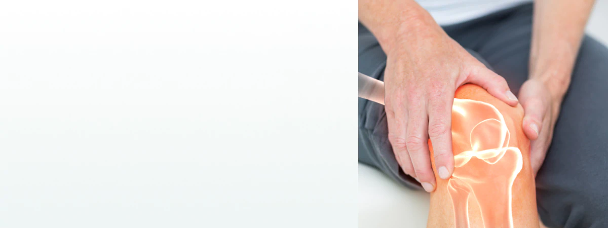 A person holding their knee with a glowing joint illustration, symbolizing the need for supplements for bone and joint health.