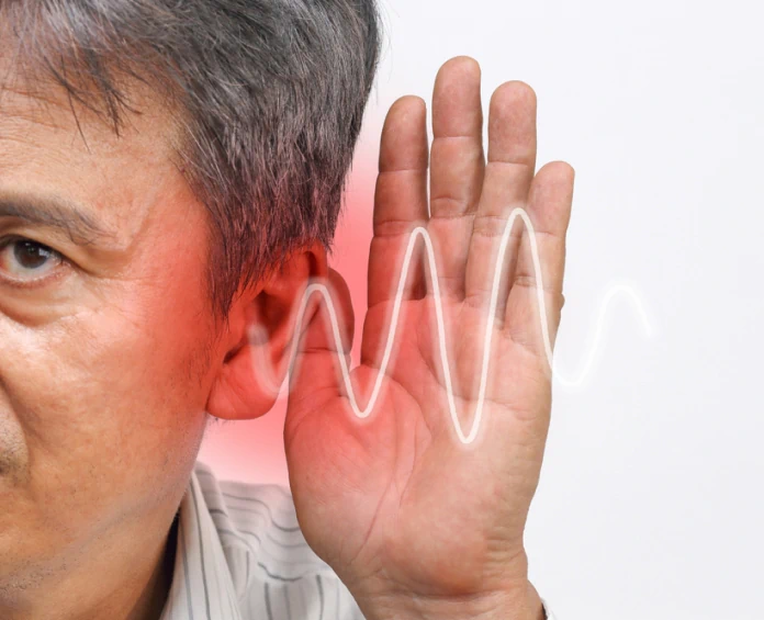 A man holding his ear with a soundwave illustration, highlighting the benefits of hearing loss supplements.