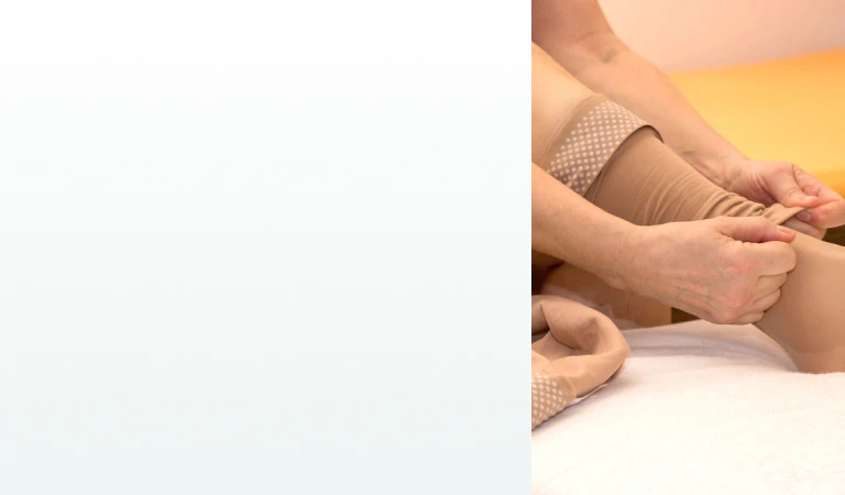 A person putting on beige compression socks, a common support tool used alongside supplements for lymph system health.