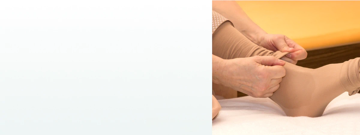 A person putting on beige compression socks, a common support tool used alongside supplements for lymph system health.