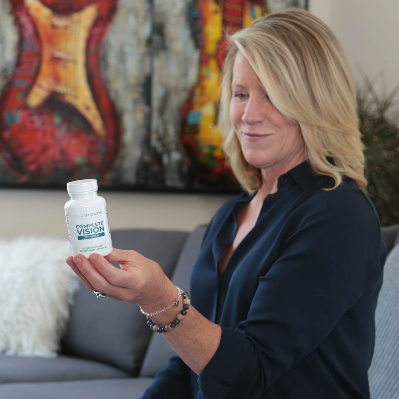 Dr. Holly Lucille holding a bottle of Complete Vision Formula