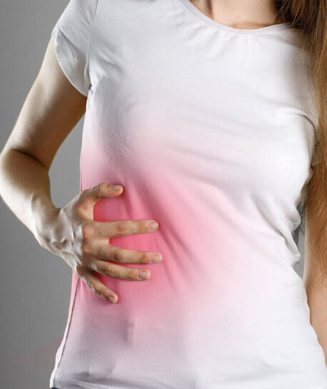 woman touching her side in pain