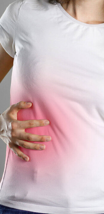 woman touching her side in pain