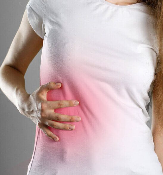 woman touching her side in pain